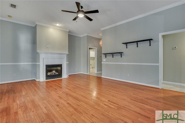 unfurnished living room featuring light hardwood / wood-style flooring, ceiling fan, and ornamental molding