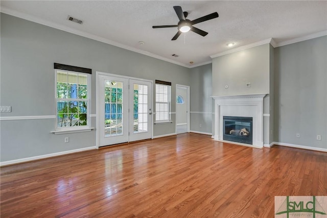 unfurnished living room with ceiling fan, a healthy amount of sunlight, and a textured ceiling