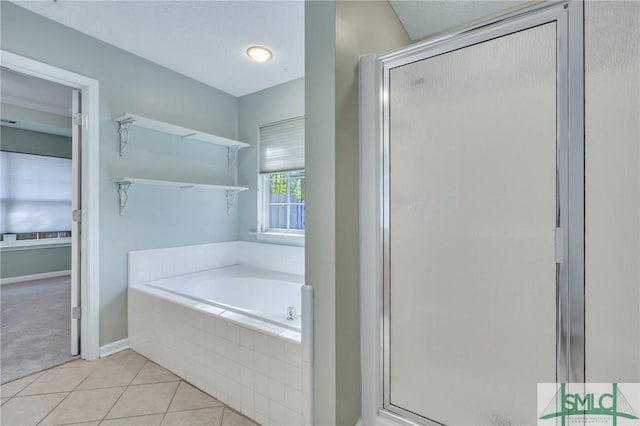 bathroom with tile patterned floors and separate shower and tub