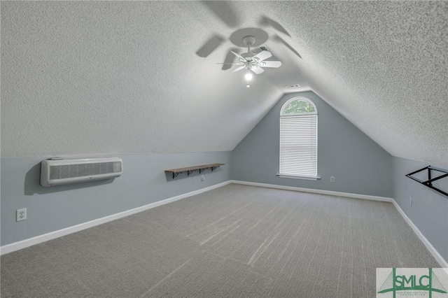 additional living space featuring carpet, a textured ceiling, ceiling fan, an AC wall unit, and lofted ceiling