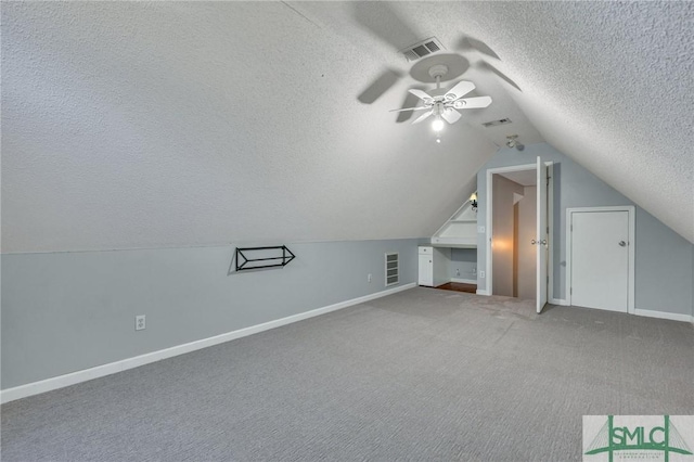 bonus room featuring vaulted ceiling, ceiling fan, carpet, and a textured ceiling