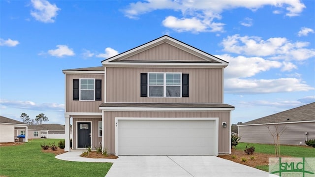 view of front of property featuring a garage and a front lawn