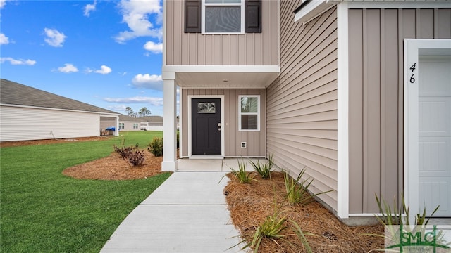 doorway to property with a lawn