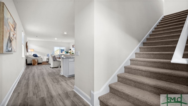 stairs with wood-type flooring