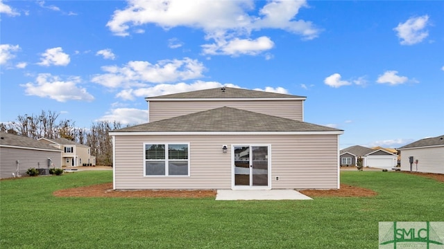 rear view of house with a patio area and a lawn