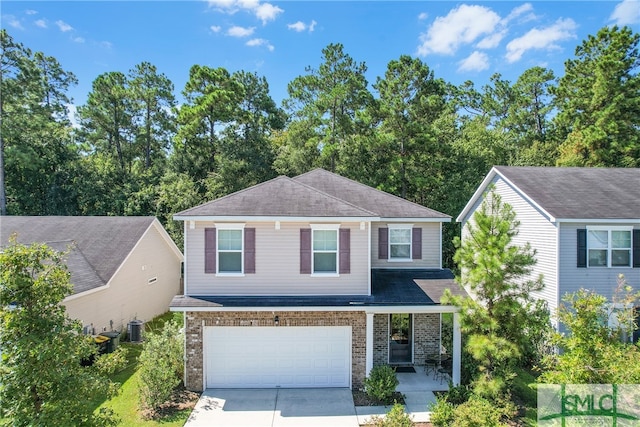 view of front of house featuring a garage, concrete driveway, brick siding, and central AC unit