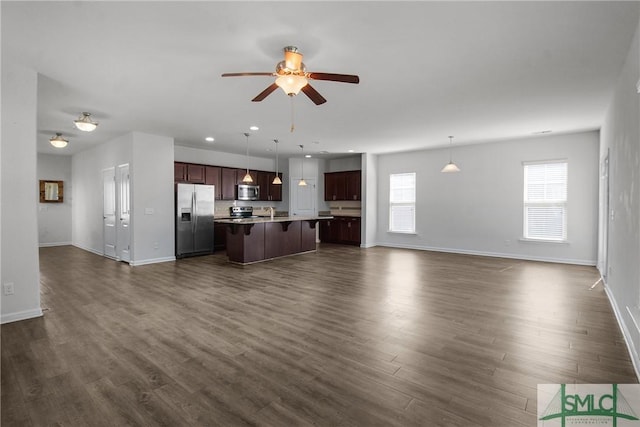 unfurnished living room featuring dark wood-type flooring, recessed lighting, baseboards, and a ceiling fan