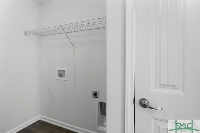 clothes washing area featuring laundry area, baseboards, dark wood-style floors, hookup for an electric dryer, and washer hookup