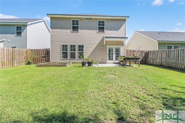 back of property featuring a patio area, a fenced backyard, french doors, and a yard