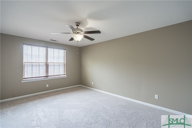 empty room featuring ceiling fan and carpet