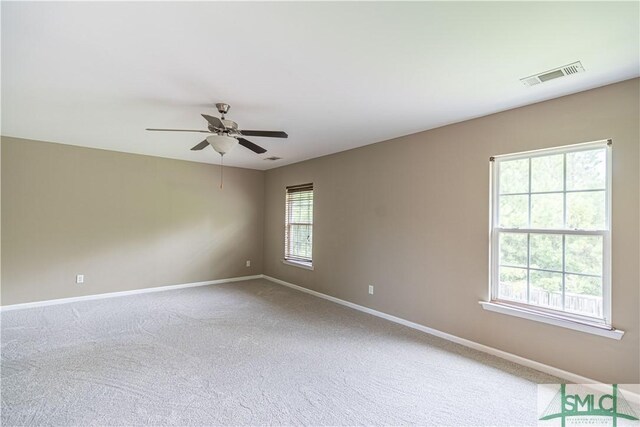 carpeted empty room featuring ceiling fan