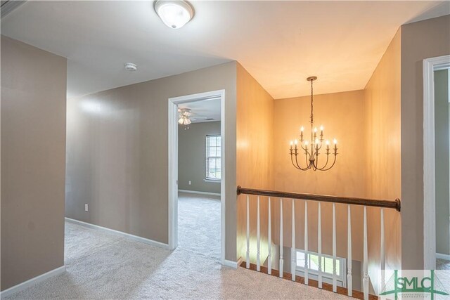 corridor featuring carpet and an inviting chandelier