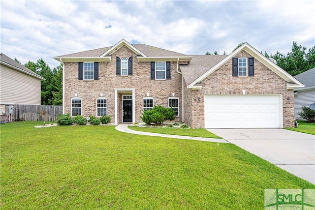 colonial inspired home with brick siding, an attached garage, fence, driveway, and a front lawn