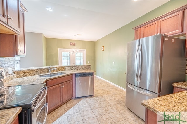 kitchen featuring sink, light tile patterned flooring, pendant lighting, and stainless steel appliances