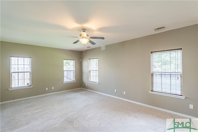 unfurnished room featuring ceiling fan and light carpet