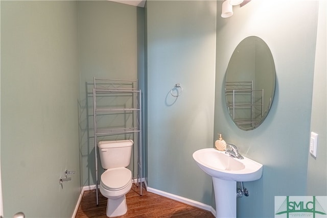 bathroom with toilet and wood-type flooring