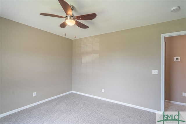 carpeted empty room featuring ceiling fan