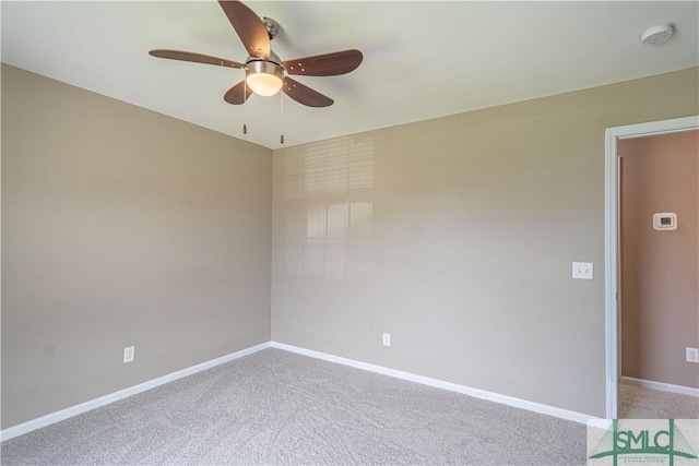 spare room with ceiling fan, baseboards, and carpet flooring