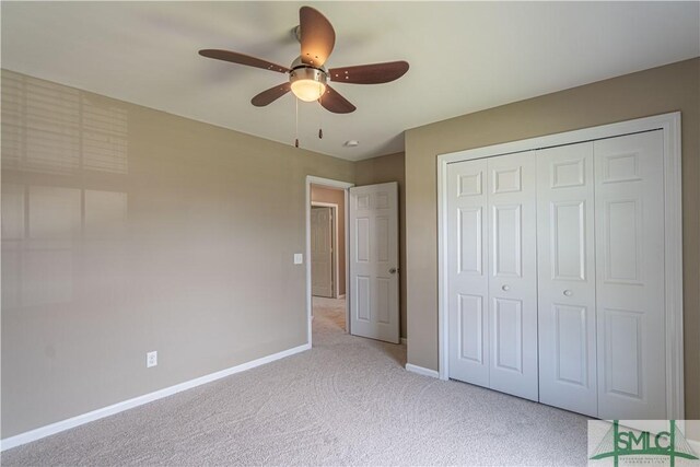 unfurnished bedroom featuring ceiling fan, light carpet, and a closet