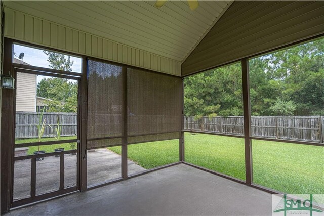 unfurnished sunroom featuring ceiling fan and lofted ceiling