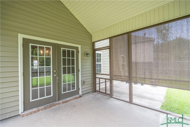 unfurnished sunroom with vaulted ceiling and french doors