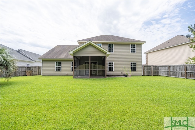 back of house with a sunroom and a lawn