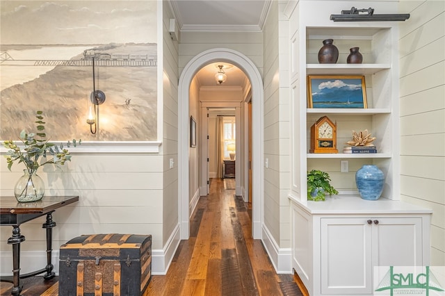 hall with crown molding, dark hardwood / wood-style floors, and built in shelves