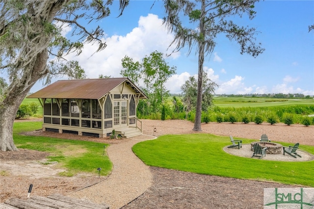 view of yard featuring a rural view and a sunroom