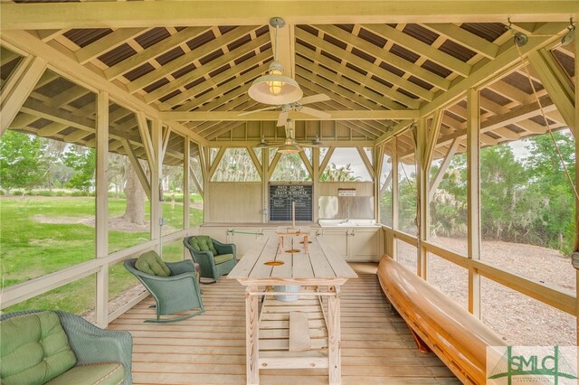 unfurnished sunroom with ceiling fan