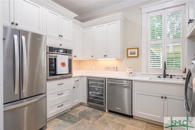 kitchen with wine cooler, stainless steel appliances, a wealth of natural light, and white cabinets