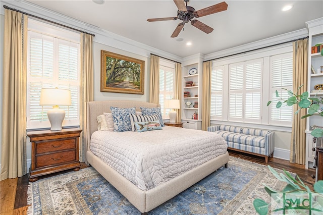 bedroom featuring hardwood / wood-style floors, crown molding, and ceiling fan