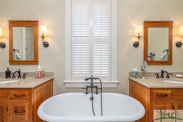 bathroom featuring vanity, a bath, and plenty of natural light