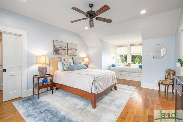 bedroom featuring vaulted ceiling, light hardwood / wood-style floors, and ceiling fan