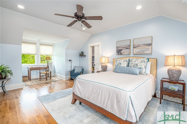 bedroom with light hardwood / wood-style flooring, lofted ceiling, and ceiling fan