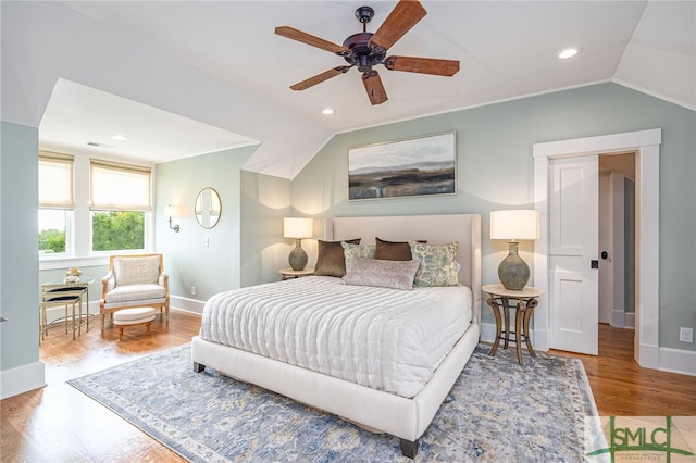 bedroom featuring vaulted ceiling, wood-type flooring, and ceiling fan