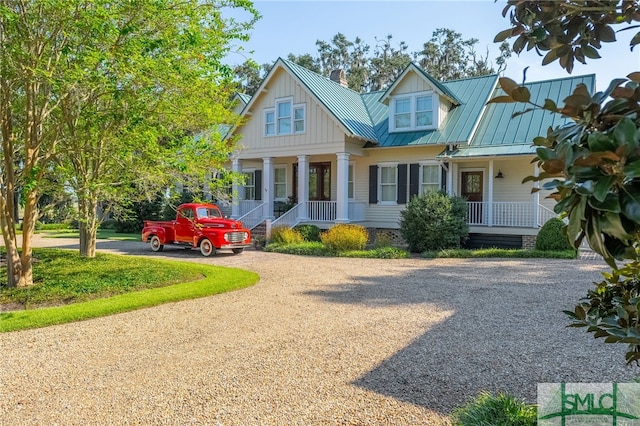 1654 Dublin Dr, Richmond Hill, GA 31324 - view of front facade featuring metal roof, covered porch, and a standing seam roof