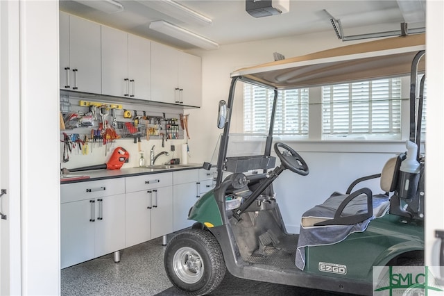 garage with a garage door opener and sink