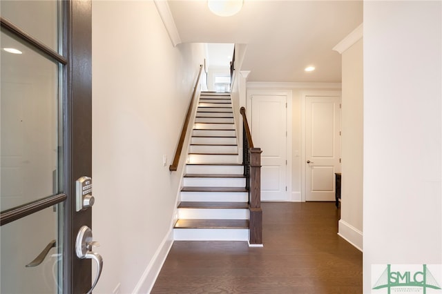 stairs featuring ornamental molding and hardwood / wood-style floors