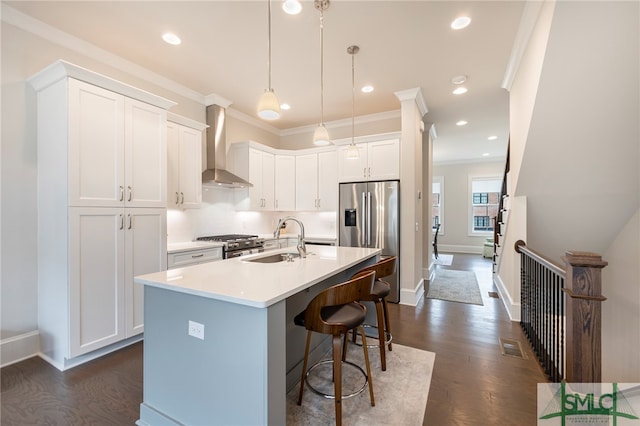 kitchen with white cabinetry, sink, wall chimney exhaust hood, dark wood-type flooring, and ornamental molding