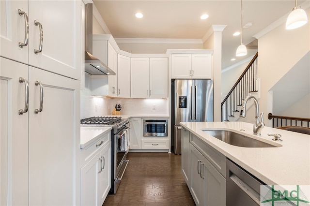 kitchen featuring crown molding, stainless steel appliances, sink, wall chimney range hood, and dark wood-type flooring