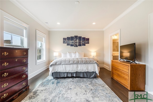 bedroom featuring crown molding, ensuite bathroom, and dark hardwood / wood-style floors