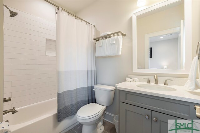 full bathroom with tile patterned flooring, shower / bath combination with curtain, toilet, and vanity