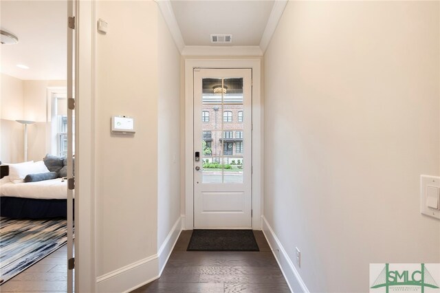 doorway to outside featuring ornamental molding and dark hardwood / wood-style flooring