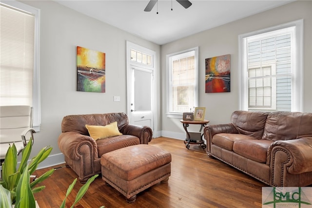 living room with ceiling fan and dark wood-type flooring