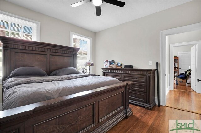 bedroom featuring dark hardwood / wood-style flooring and ceiling fan