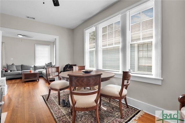 dining room with hardwood / wood-style flooring, plenty of natural light, and ceiling fan