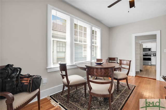 dining space featuring ceiling fan and light hardwood / wood-style flooring