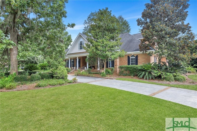 view of front of house with a front yard and covered porch