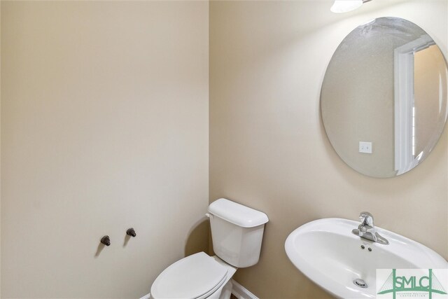 bathroom featuring sink and toilet