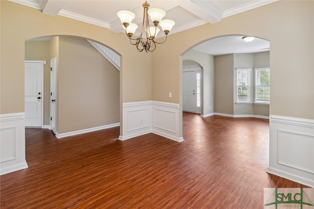 empty room with dark hardwood / wood-style floors, crown molding, a notable chandelier, and beam ceiling